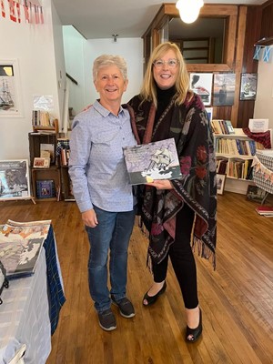 MLA Karla MacFarlane purchasing a DD book at the Welcome Centre