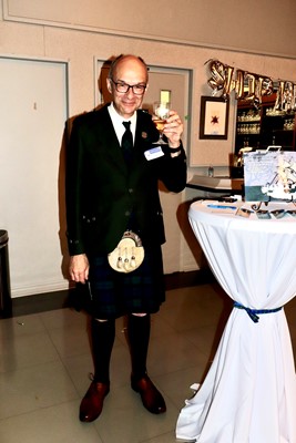 John B enjoys a beverage at the banquet, Cheers John!